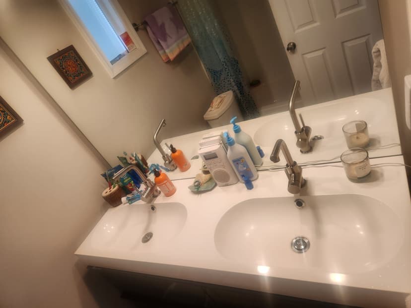 Sanitized bathroom sink and vanity in a professionally cleaned home